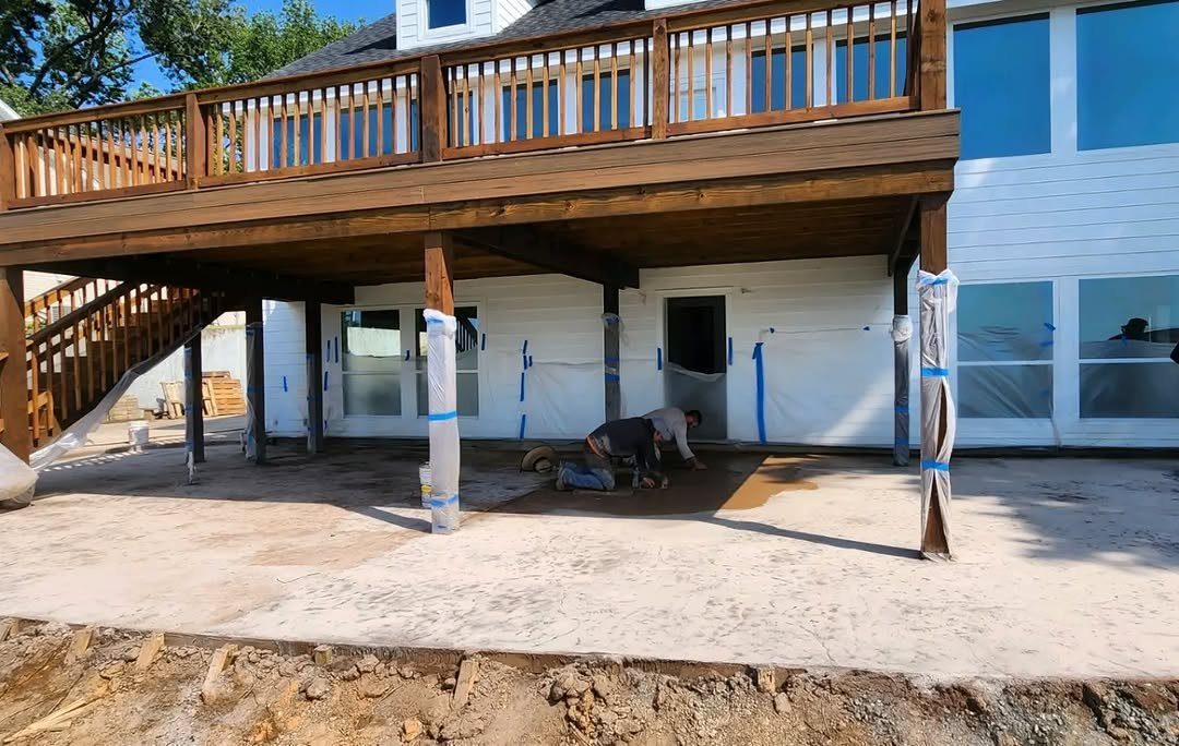 A custom two-story home with a wraparound deck, built by Willmer Construction